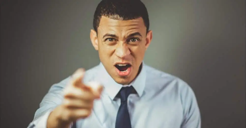 An angry man points finger on the reader