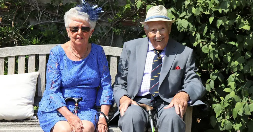 Elder couple sits on a bench